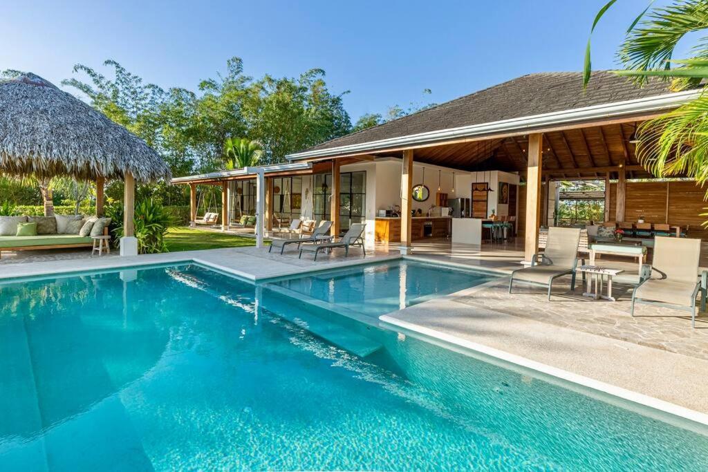 a swimming pool in front of a house at Casa la Onda in Santa Teresa Beach