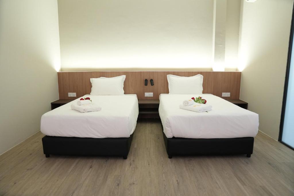 Postel nebo postele na pokoji v ubytování Roxy Hotel Aiman