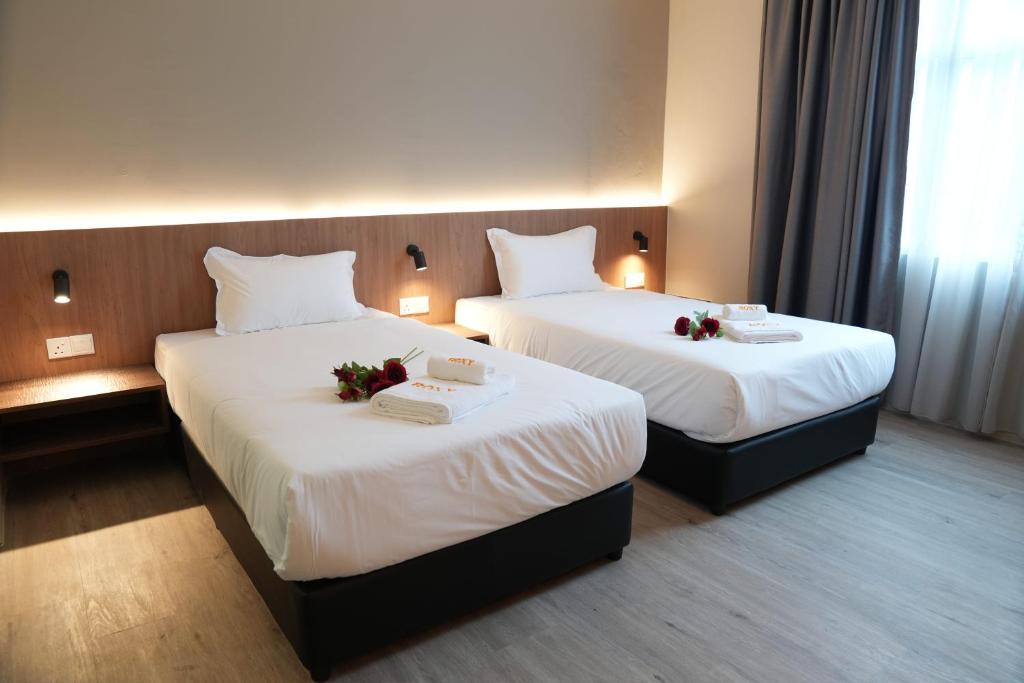 Postel nebo postele na pokoji v ubytování Roxy Hotel Aiman