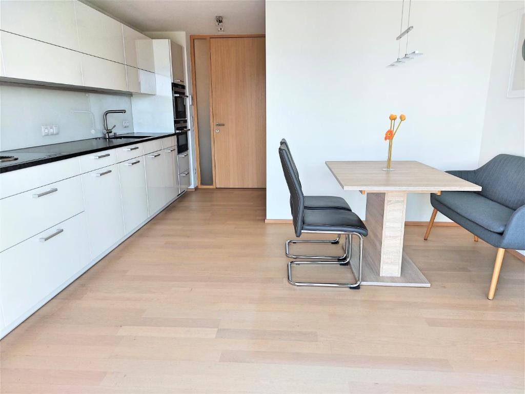 a kitchen with a table and chairs and a dining room at Wohnung *AusZeit* in Weiler