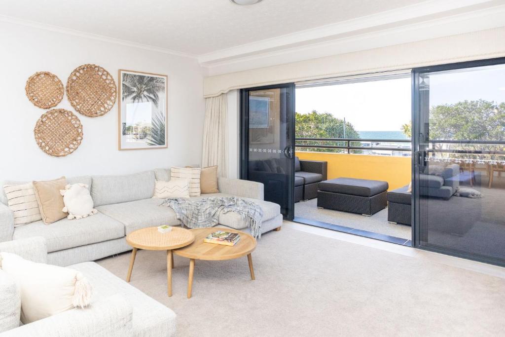 a living room with a couch and a table at Kingscliff Paradise with Ocean Views in Kingscliff