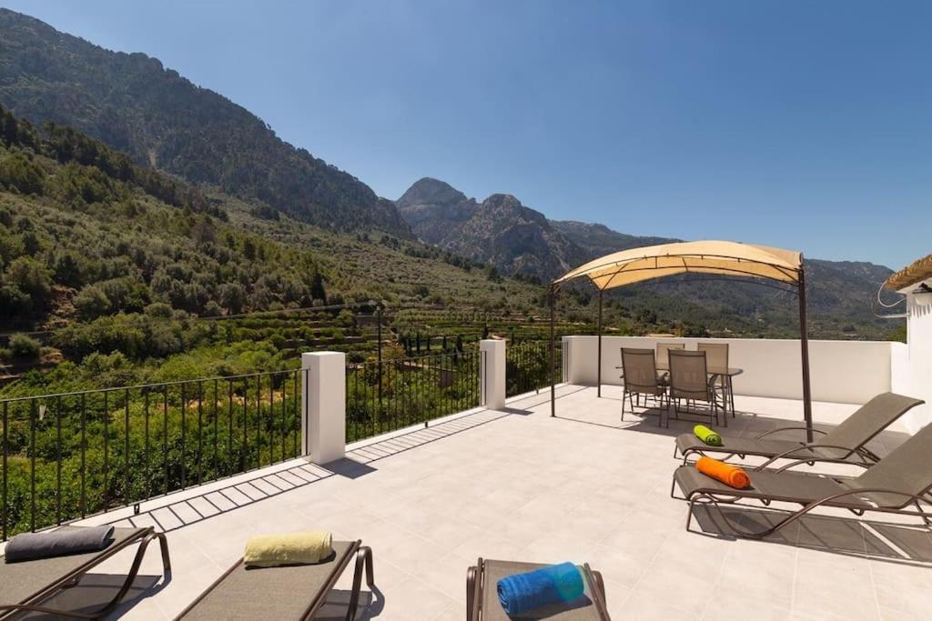 a patio with chairs and a view of a mountain at Town House Alba in Fornalutx in Fornalutx