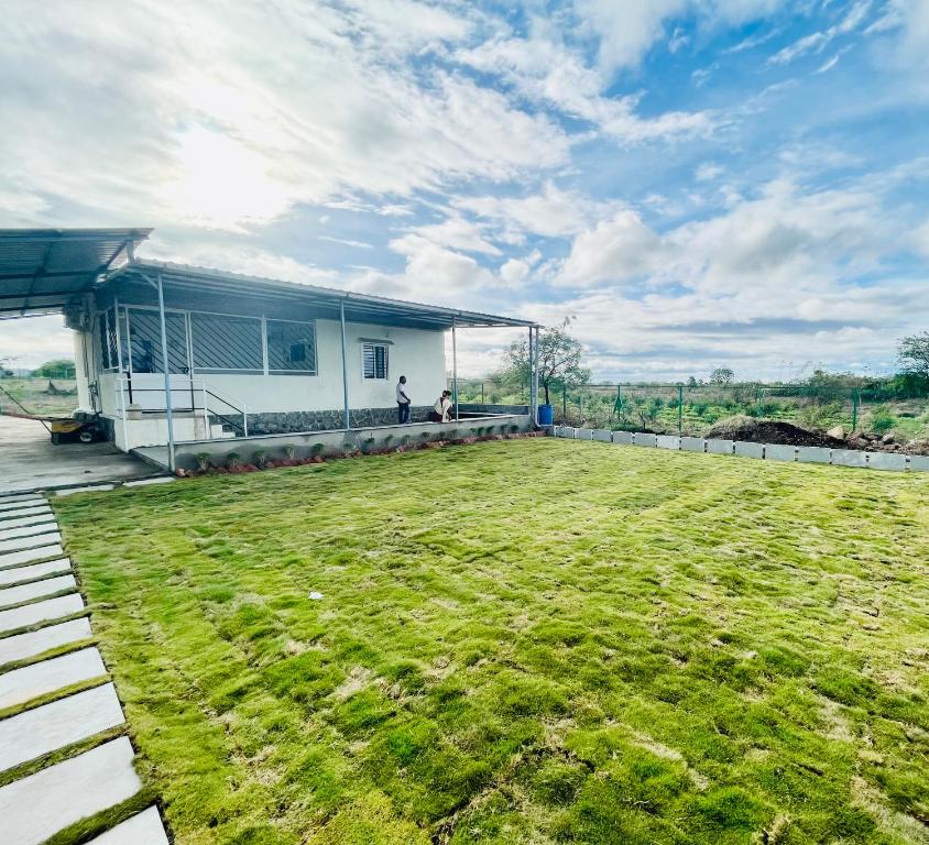 a house with a large lawn in front of it at Saagvan Villa in Pune