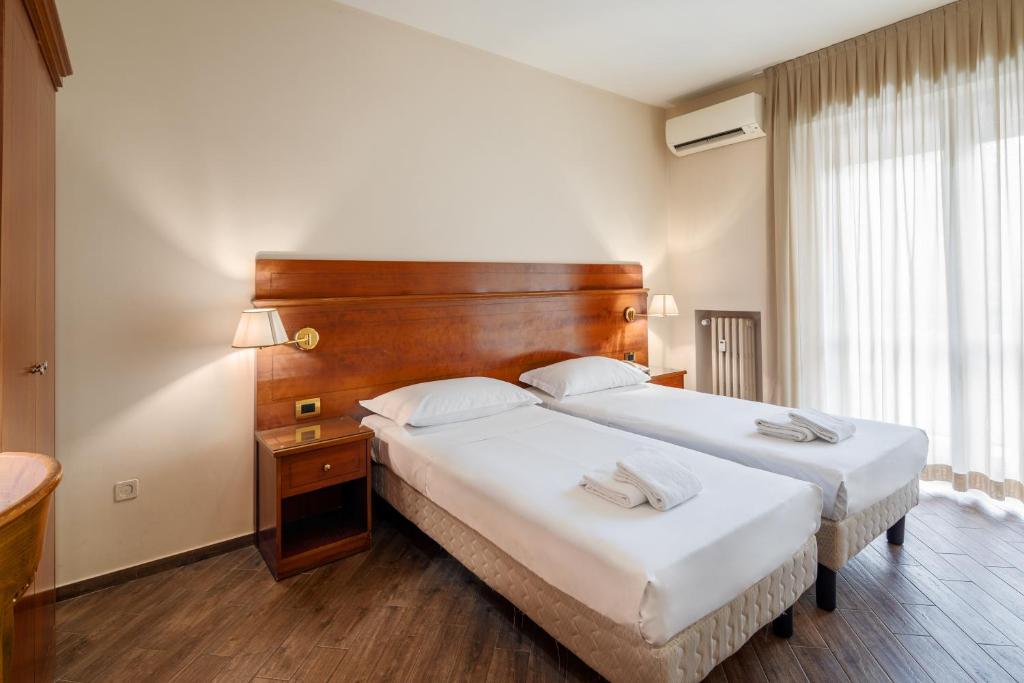 Postel nebo postele na pokoji v ubytování Hotel Excelsior Pavia