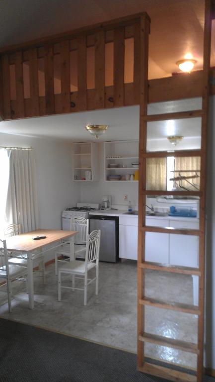 a kitchen with a table and chairs in a room at All Seasons Campground in Ninilchik