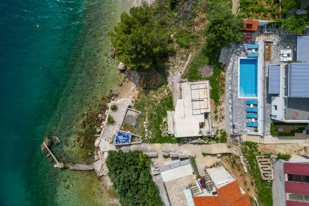 eine Luftansicht einer Insel im Wasser in der Unterkunft Pool Apartments Sweet Oasis Omiš - Happy Rentals in Lokva Rogoznica