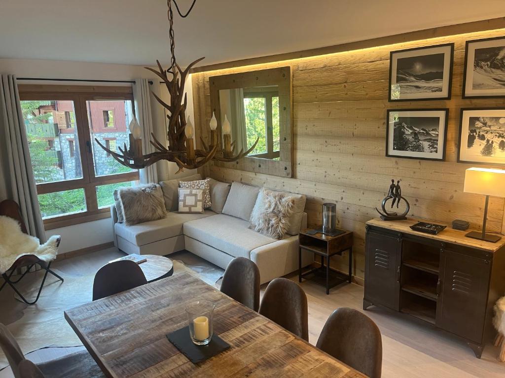 a living room with a couch and a table at Arc 1950 Ski in Ski out and Spa- Newly refurbished 153 Sources De Marie- 2 bedroom , 2 bathroom-Sleeps 4-6, Mont Blanc view from every window, Free WiFi in Arc 1950