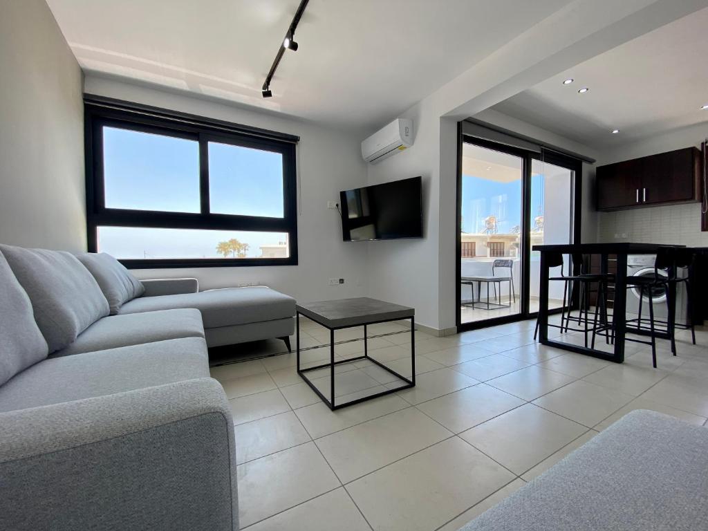 een woonkamer met een bank en een tafel bij Sea La Vie #1 - Luxury Seaview apartment in Paphos City