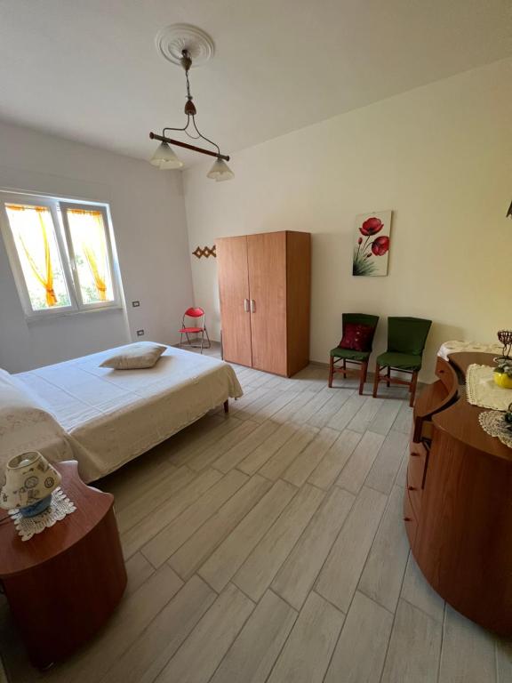 1 dormitorio con 1 cama, mesa y sillas en Salernobnb, en Salerno
