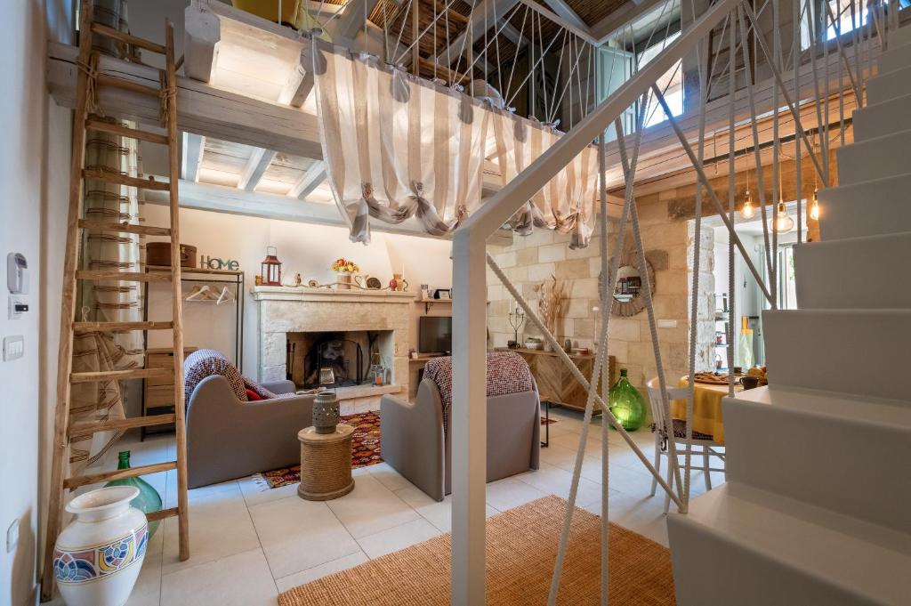 a living room with stairs and a fireplace at La dimora Elia' in Muro Leccese
