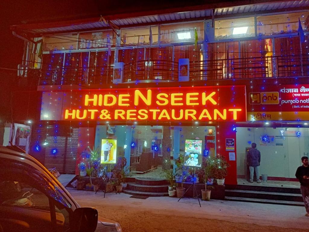 a building with a sign that reads hide keeperhoff and restaurant at Hide and Seek by StayApart in Dehradun