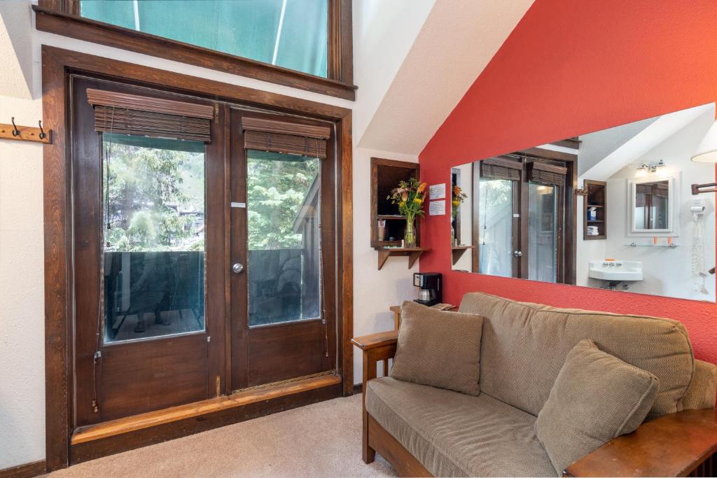 a living room with a couch and a window at Manitou Lodge 9 by Alpine Lodging Telluride in Telluride