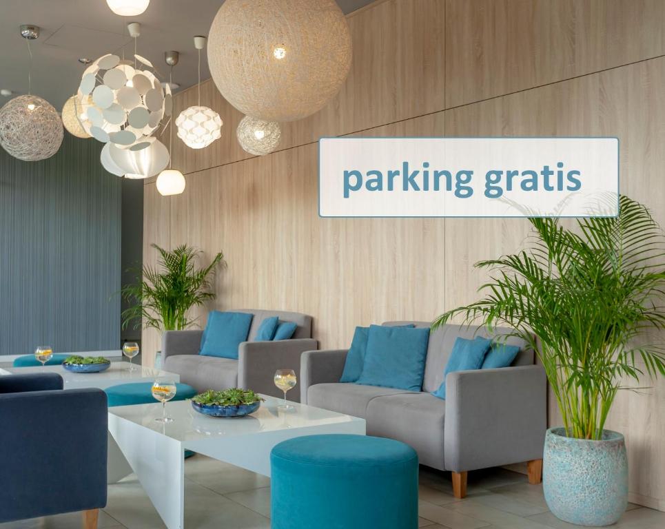 a lobby with couches and tables and a sign saying parking grids at Hotel Zatoka in Gdańsk