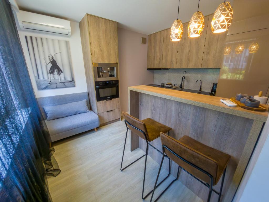 a kitchen with a bar and some chairs in a room at Like Home 1 Perfect Classic Duo in Świdnica