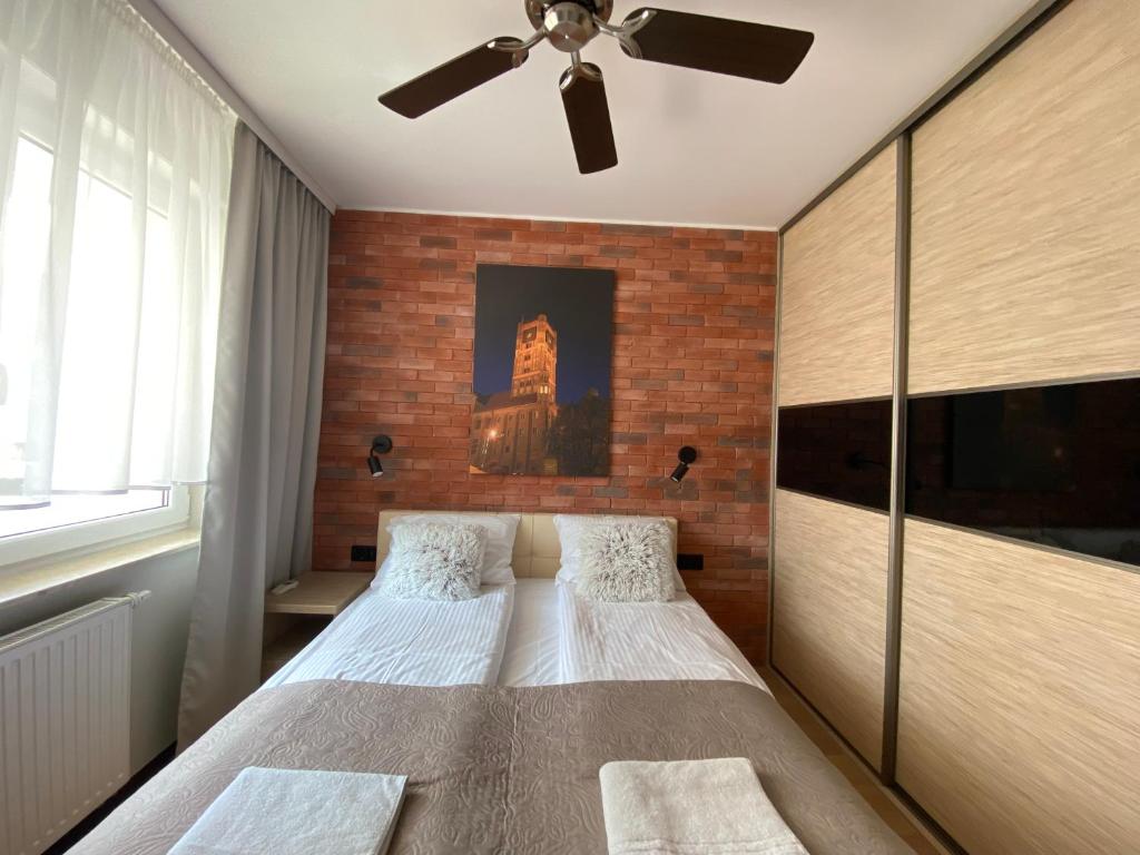 Posteľ alebo postele v izbe v ubytovaní Apartament Toruń