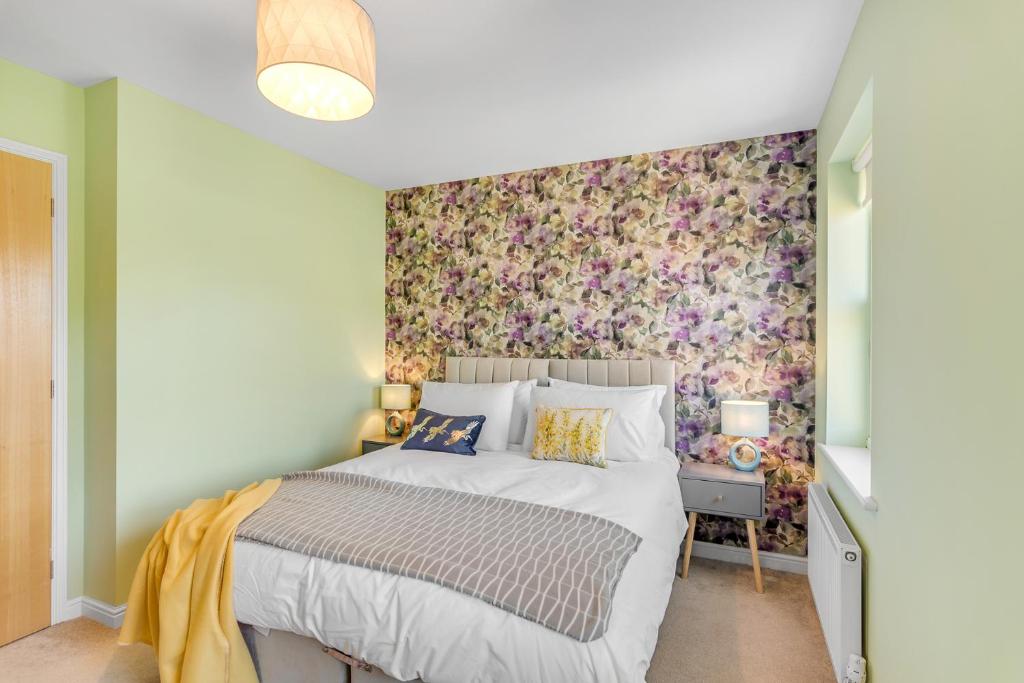 a bedroom with a bed with a floral wallpaper at #034 Saunders Rest in Norwich