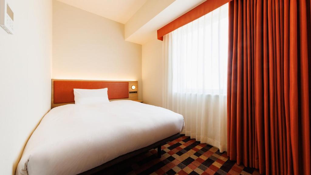 Postel nebo postele na pokoji v ubytování JR-East Hotel Mets Koenji