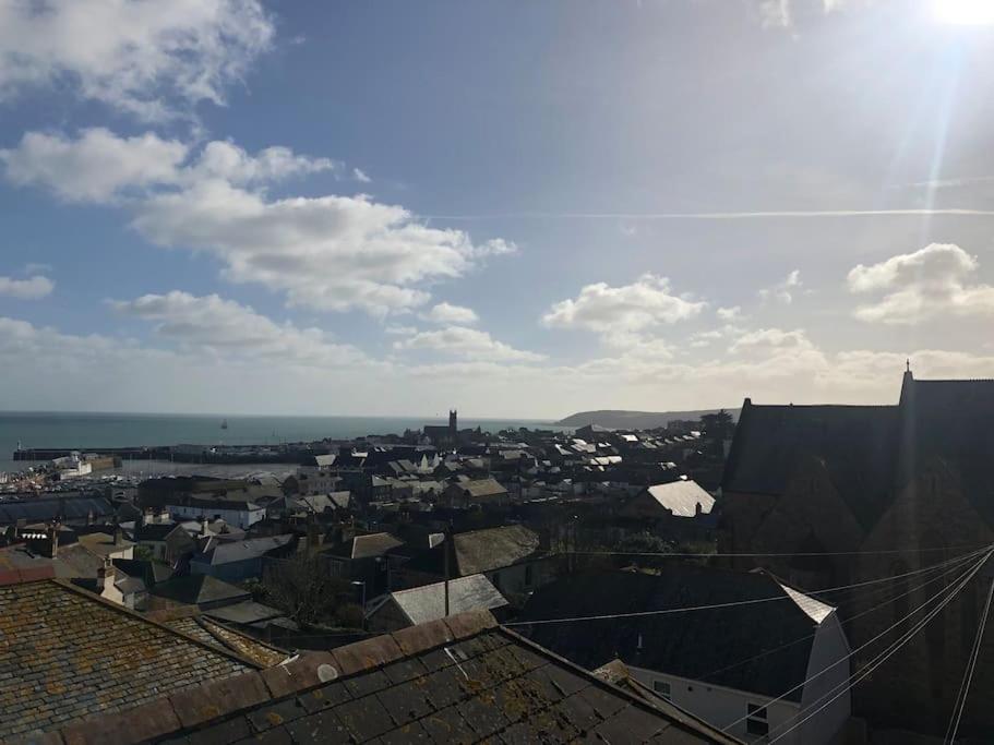 a view of a city from the roof of a building at Modern Attic Studio Apartment with harbour views in Penzance