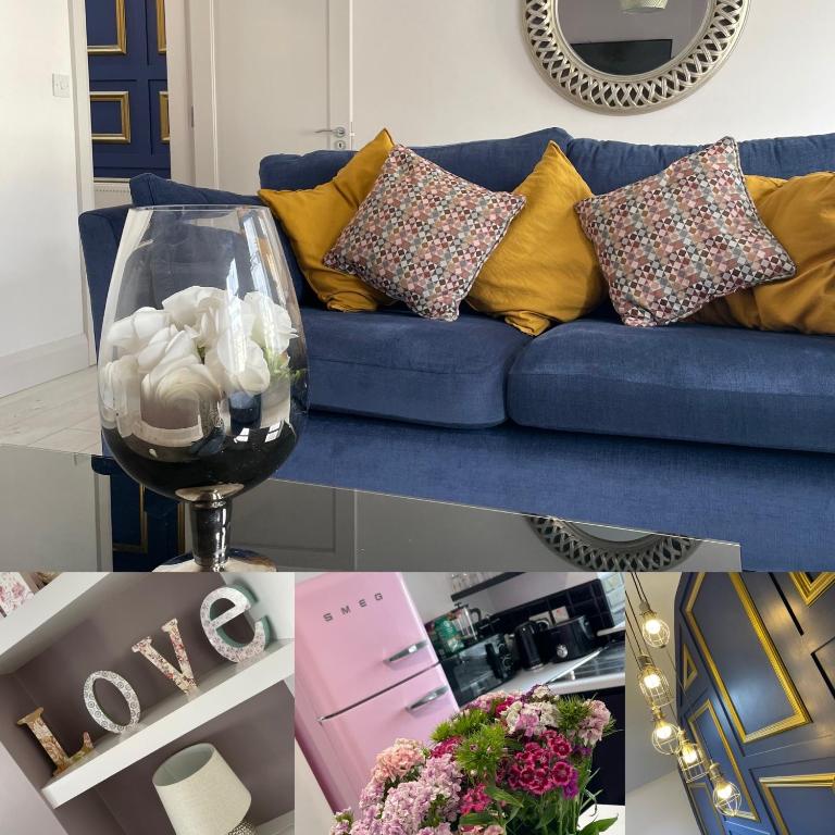 a living room with a blue couch with yellow pillows at No 16 Main Accommodation in Buncrana