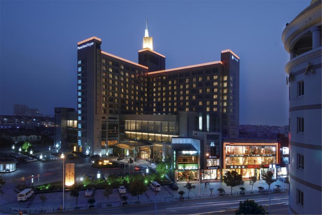 a large building with a street in front of it at night at Plaza Hotel Yuyao in Yuyao