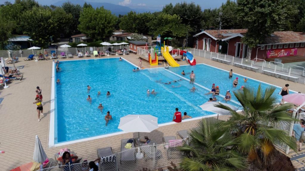 an overhead view of a swimming pool with people in it at Sereno Camping Holiday in Moniga