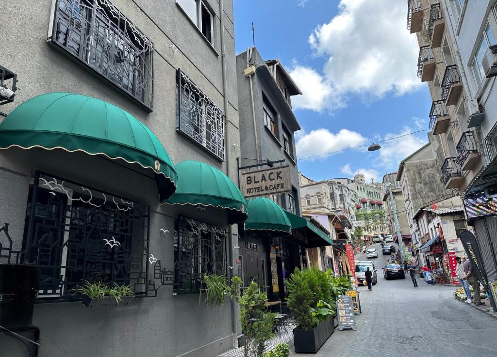 a building with green awnings on a city street at Black Art Otel in Istanbul