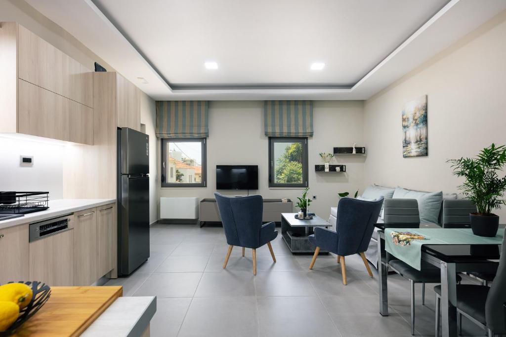 a kitchen and living room with a couch and a table at Estia Comfort House in Chania