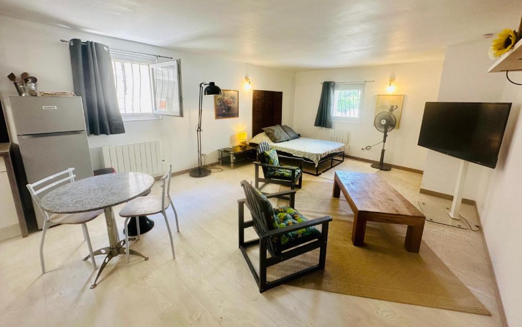 a living room with a table and a couch at Studio Torreilles village in Torreilles