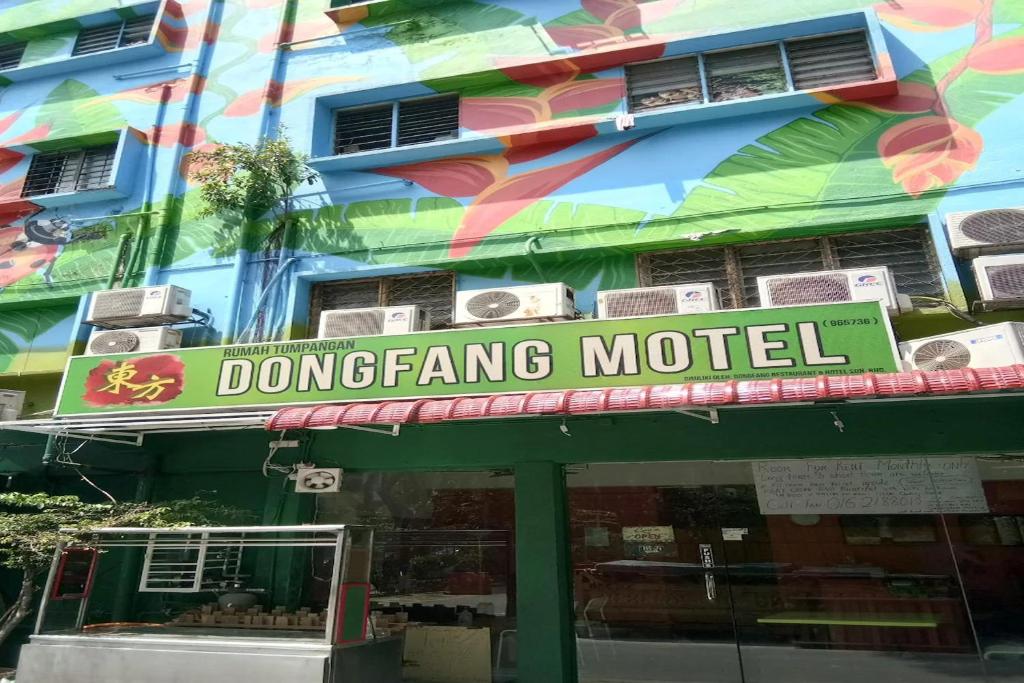 a sign for a donggang motel in front of a building at Dongfang Motel in Kuala Lumpur