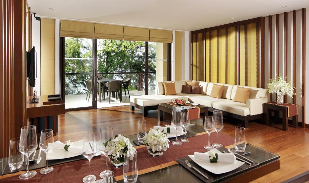 a living room with a couch and a table at Mövenpick Resort Bangtao Beach Phuket in Bang Tao Beach