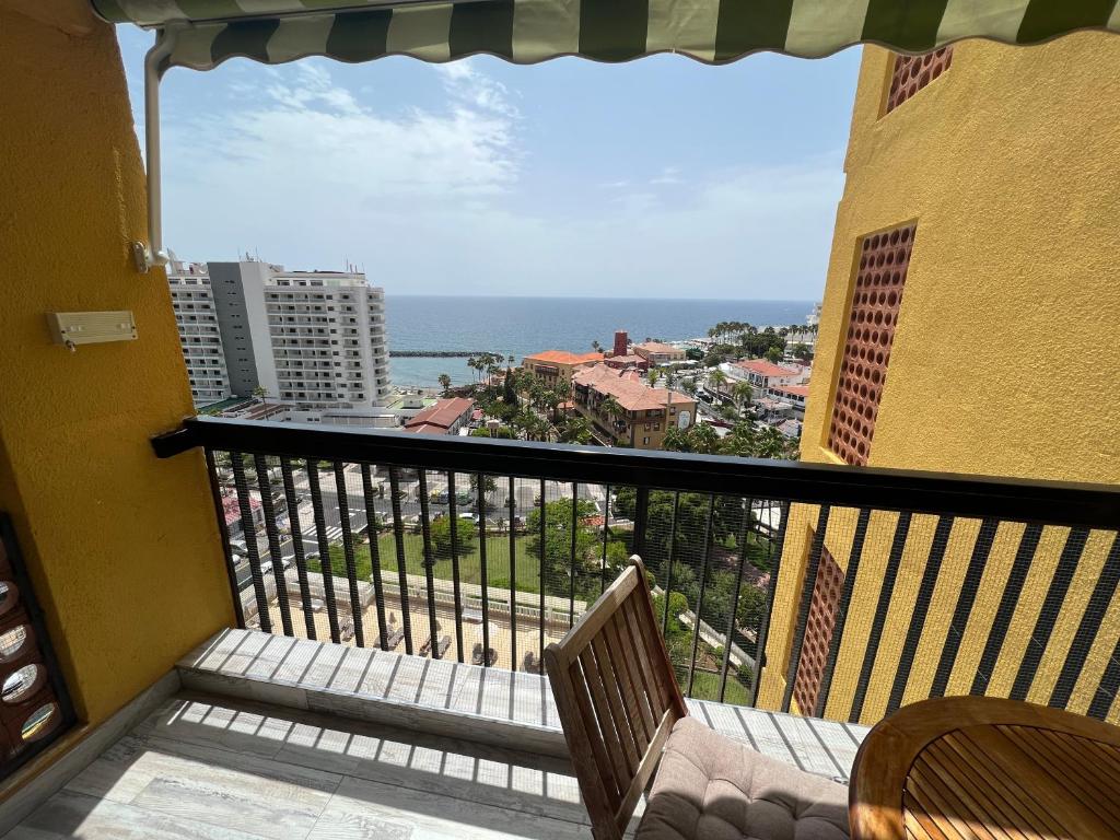 a balcony with chairs and a view of the ocean at Lookout Point Tenerife Holiday Apartment Las Americas in Playa Fañabe