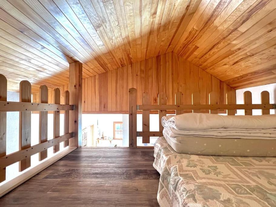 a large wooden room with two bunk beds in it at Charmant Studio 25 m² avec mezzanine et piscine in Tilh