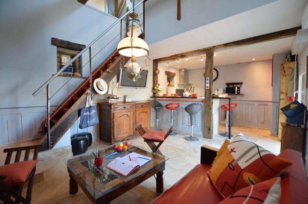 a living room with a couch and a table at La porcherie du pet en l'air in Saint Malo