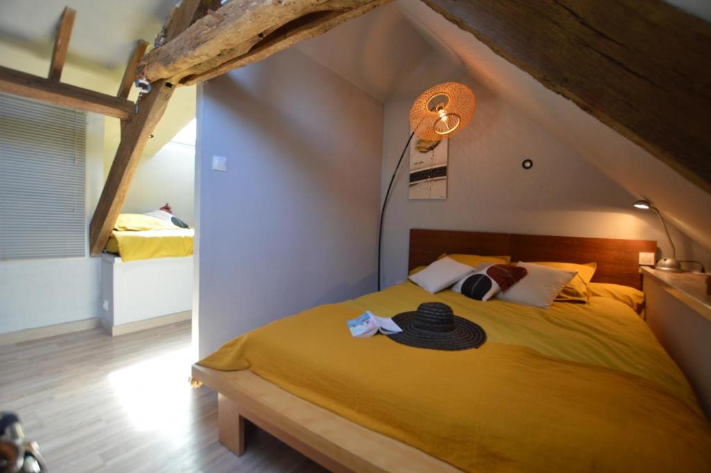 a bedroom with a yellow bed in a room at La porcherie du pet en l&#39;air in Saint Malo