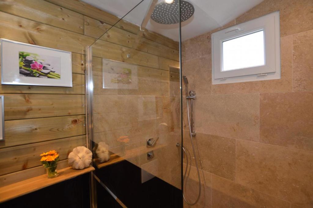 a shower with a glass door in a bathroom at La porcherie du pet en l&#39;air in Saint Malo