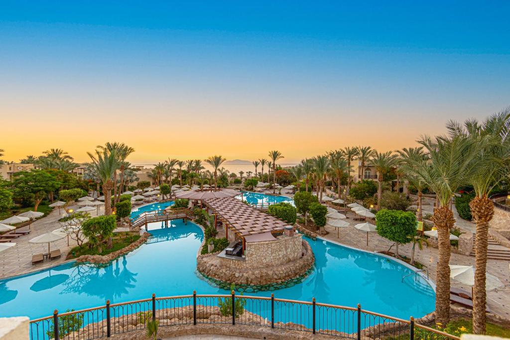 an aerial view of a resort pool with palm trees at The Grand Hotel Sharm El Sheikh in Sharm El Sheikh