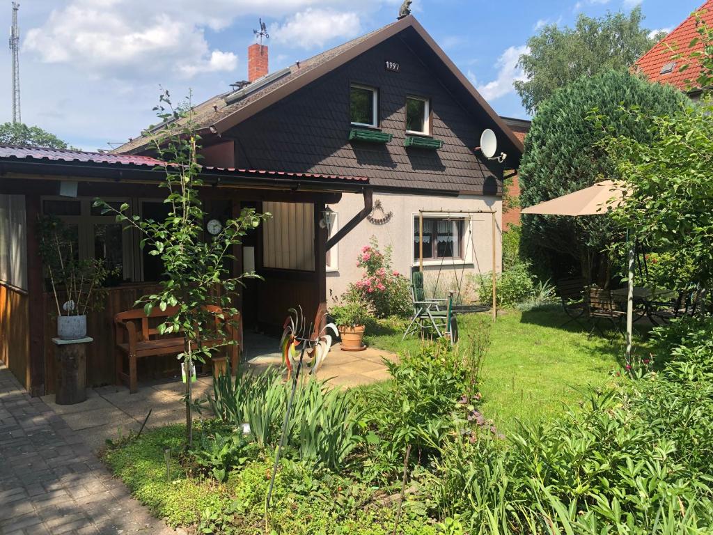 a house with a garden and a yard with a patio at Haus am Finowkanal in Eberswalde