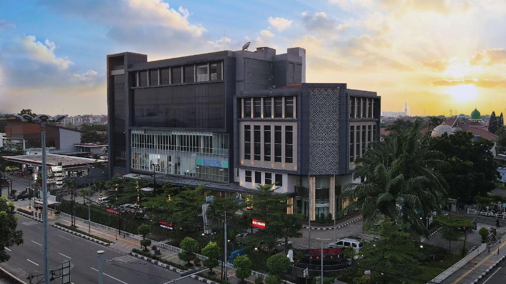 a large building in a city with a street at Luxury Inn Arion Hotel in Jakarta