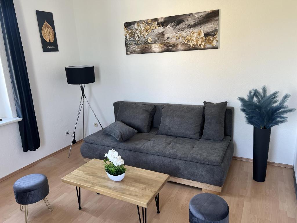 a living room with a couch and a table at Apartment 2 - Haus Lausitzring in Annahütte