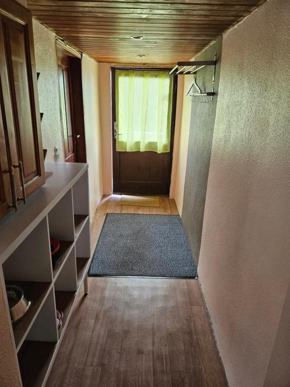 a hallway with a door and a rug in a room at Rural in Assens