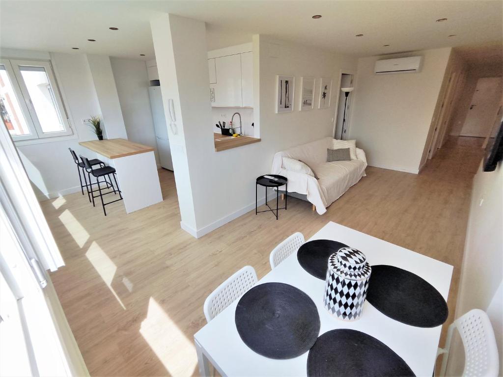 a kitchen and living room with a table and chairs at Aljarafe Central Square - by Pro Apartments in San Juan de Aznalfarache