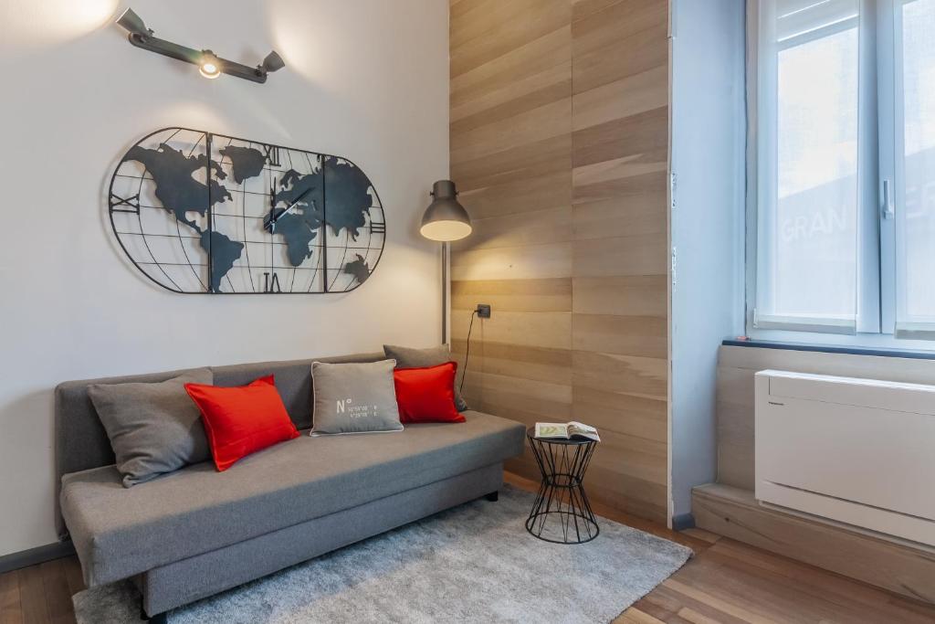 a living room with a couch and a map on the wall at Casa Viganò in Como