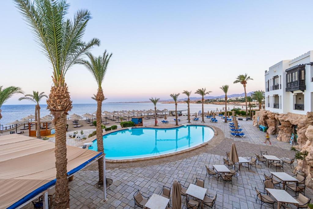 a view of the pool and beach at a resort at The Sharm Plaza in Sharm El Sheikh