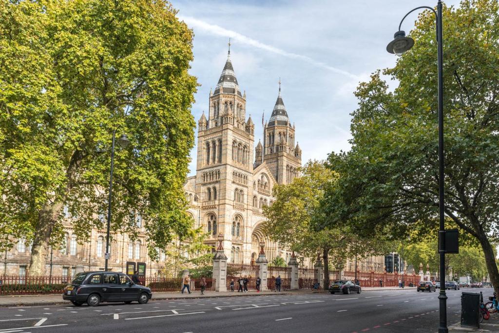 a car parked in front of a large building at SouthKen Palace Suites in London