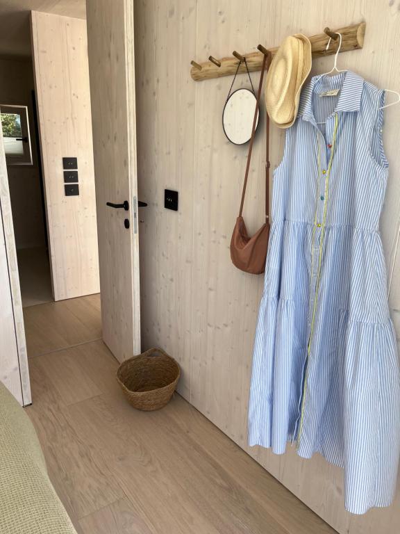 a blue dress hanging on a wall in a room at BUQEZ ECO RESORT - Beach Villas 2 and 8 - Seaview, new wifi! in Drage