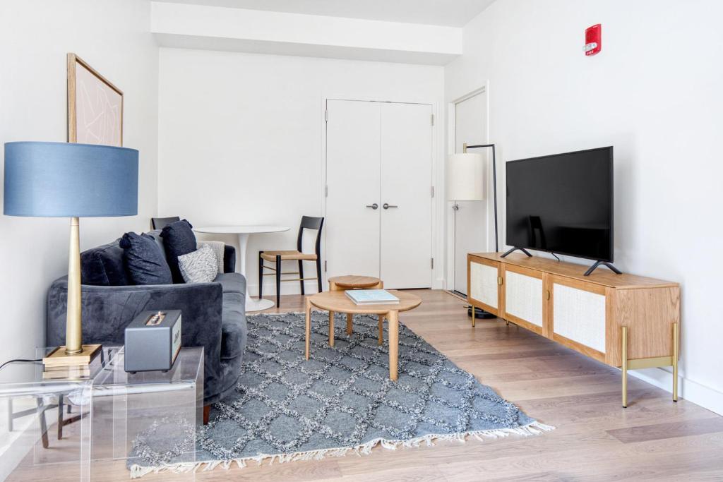 a living room with a couch and a tv at Back Bay Studio w Gym nr Newbury St BOS-458 in Boston