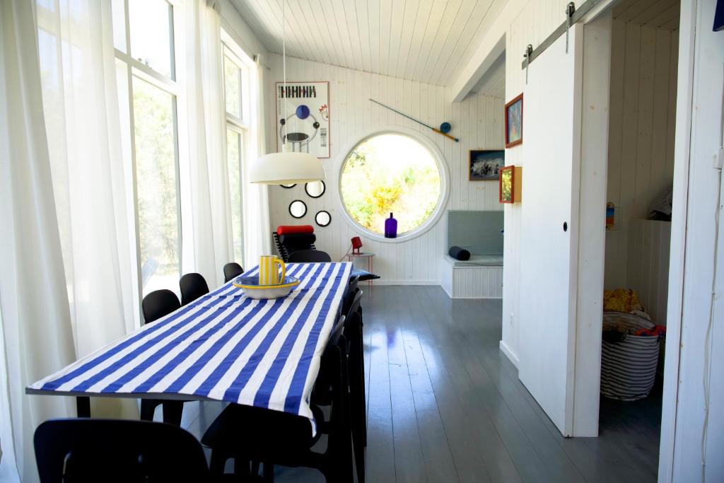 a dining room with a blue and white table and chairs at Holldiay house near the beach in Yderby