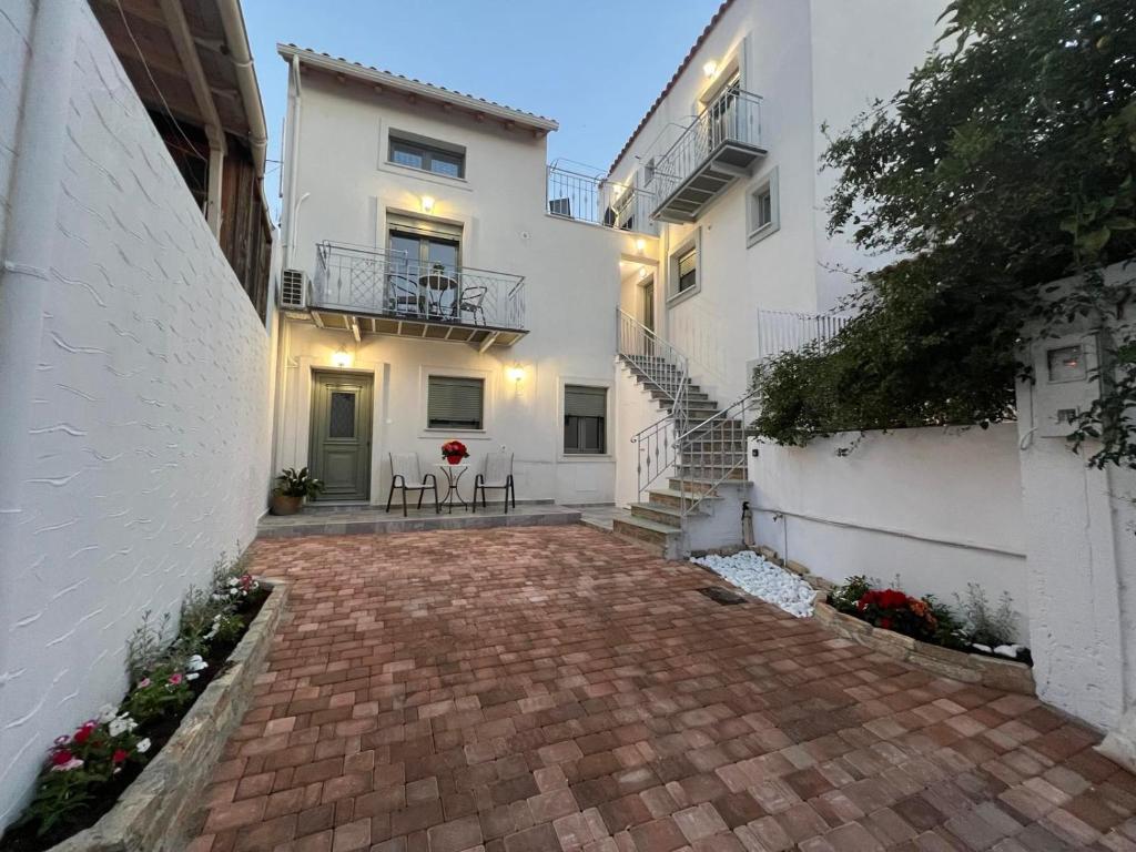 a brick walkway in front of a white building at Vespista Boutique in Skiathos Town