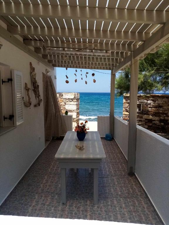 a table on a patio with a view of the ocean at Spilios House in Apollon