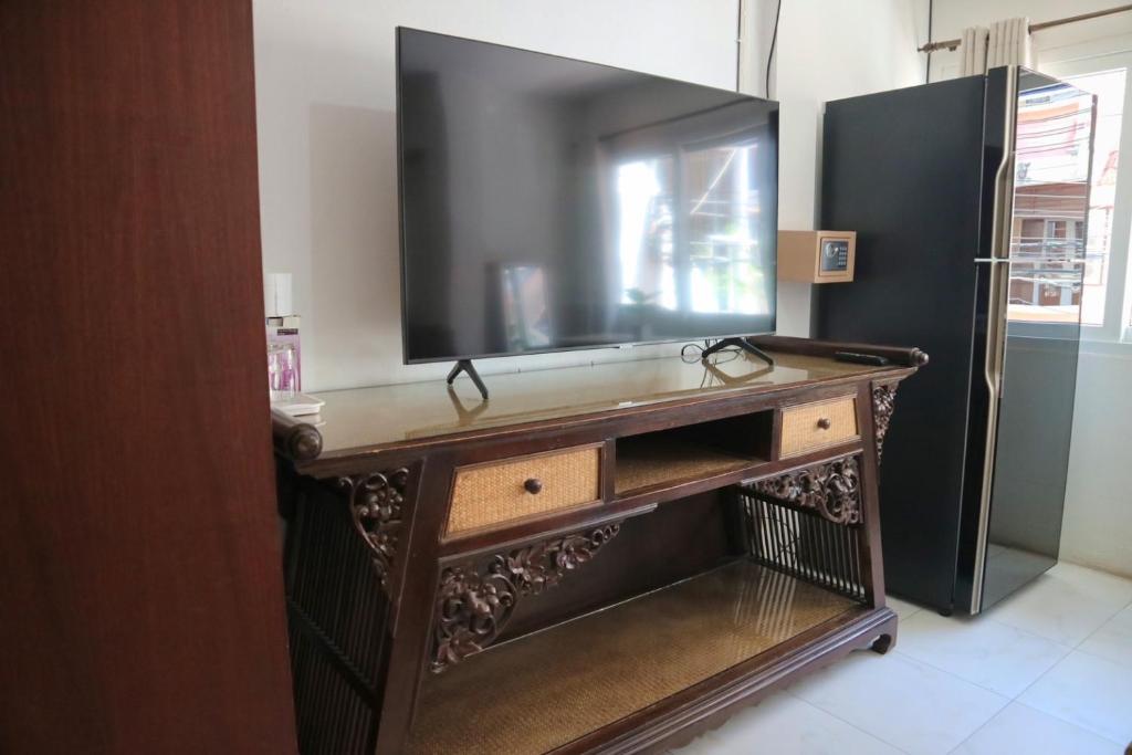 a television sitting on top of a wooden table at Sunshine Hotel in Hua Hin